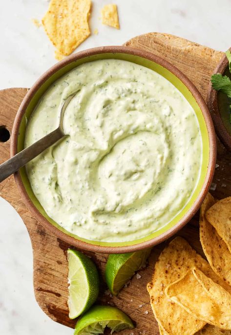 This easy cilantro lime crema adds zesty flavor to tacos, burritos, grilled veggies, and more! It's made with simple, healthy ingredients like Greek yogurt, garlic, fresh cilantro, and lime juice. Cilantro Lime Crema Recipe, Lime Crema Recipe, Cilantro Lime Crema, Homemade Taquitos, Crema Recipe, Lime Crema, Grilled Sweet Potatoes, Zesty Sauce, Taco Salad Recipes