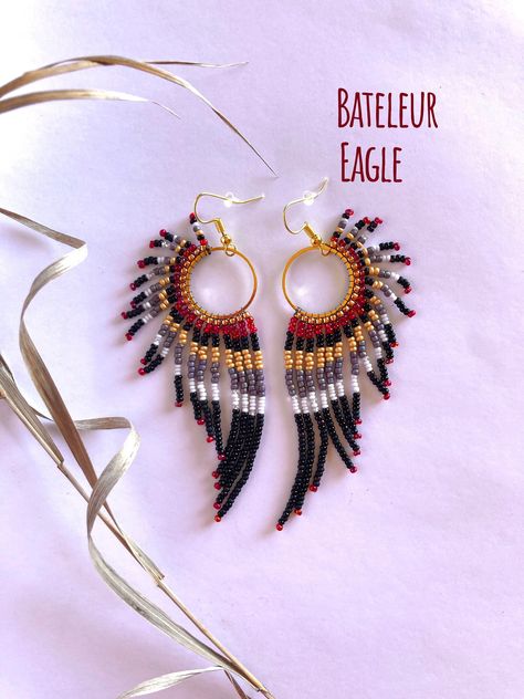 "Handmade, lightweight, durable, beaded dangle earrings. For bird, raptor, and falconer enthusiasts! Bird type: Bateleur Eagle. Native to Africa! Size: Medium hoop size, and just over 3.5 inches total length from hook to end of the longest beaded strand. Hoop size: Medium: 20mm (0.8 inches) Materials: Silver hooks, with White K hoops. Made with glass beads, 6lb mirco-infused Fireline thread, glue, and rubber earring backing. Care instructions included. Processing: Please allow 1-3 days for processing. Shipping: Sent USPS Ground. Delivery time depends on your location. Returns: You may return your item as long as you pay for return shipping. A full refund will be given if the jewelry is returned in the same condition when purchased.  40% of every raptor related sale is donated to the Rocky Native Beaded Jewelry, Beaded Earrings Patterns Free, Bateleur Eagle, Beaded Feather Earrings, Native Beaded Earrings, Beaded Feather, Seed Bead Jewelry Patterns, Beaded Jewelry Earrings, Beaded Earrings Native