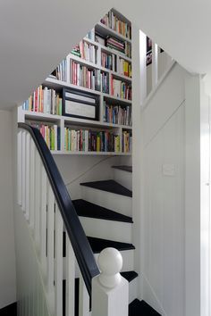 When your book collection threatens to take over the house, it’s time to tuck a bookshelf or two in an unusual place! Farmhouse Staircase Decor, Modern Farmhouse Staircase, Farmhouse Staircase, Space Saving Staircase, Staircase Decor Ideas, Diy Staircase, Staircase Decor, Attic Renovation, Attic Remodel