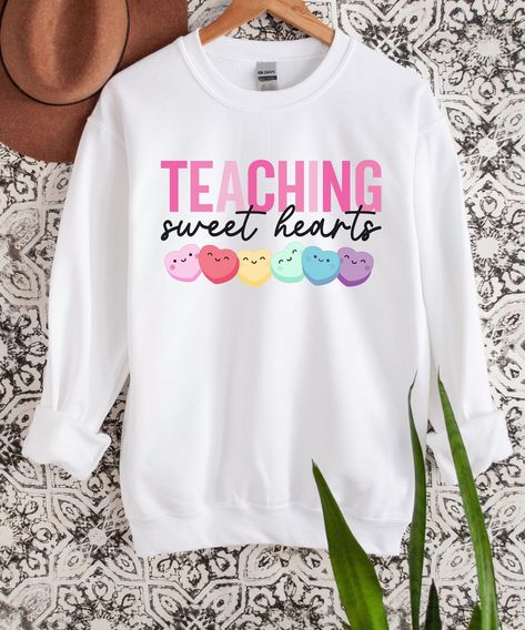 Get our Teaching Sweet Hearts Sweatshirt today! Made with love, this cozy and trendy sweatshirt is perfect for passionate educators. Inspire others with its heartwarming message and comfortable fit. Perfect as a gift or for yourself. Don't miss out! #TeacherLove #TeachingSweetHearts #PassionForEducation Teacher Cricut Ideas, Valentine’s Day Teacher Shirts, Teacher Valentines Shirt, Valentine Teacher Shirts, Valentines Teacher Shirt, Teacher Holiday Shirts, Valentines Day Teacher Shirts, Teacher Picture Day, Teacher Valentine Shirts