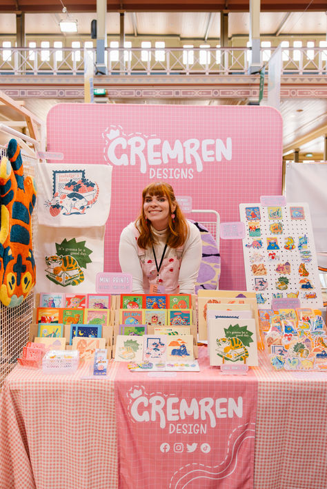 Photo by Samee Lapham Merch Booth Design, Community Table Design, Booth Price Display, Illustration Market Stall, Pink Market Stall, Creative Booth Design Ideas, Booth Art Display, Artist Booth Ideas, Market Banner Ideas