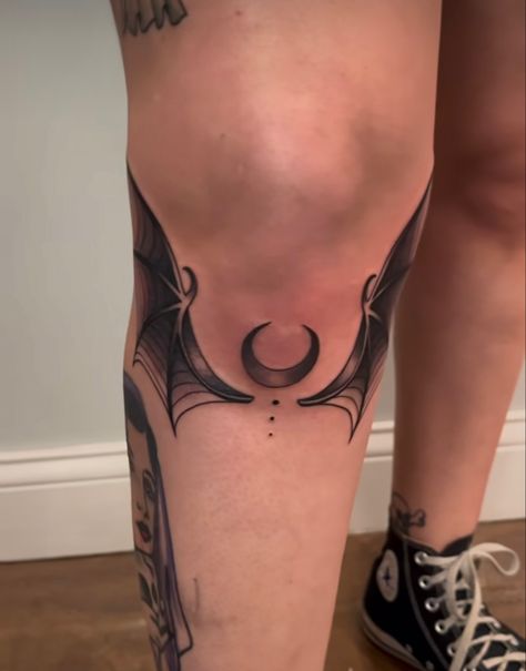 Bat Wings Under Knee Tattoo, Witchy Knee Tattoo Ideas, Crescent Moon Knee Tattoo, Bat Wing Tattoo Knee, Bats And Butterflies Tattoo, Shoulder Bat Tattoo, Dark Leg Tattoos For Women, Bat Wrapped Around Wrist Tattoo, Bat Wings Tattoo Knee