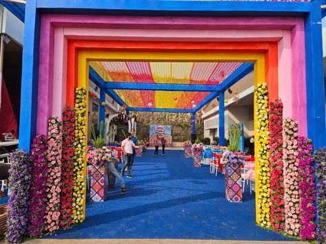 Grand Haldi & Mehendi carnival Rainbow Entrance Decoration, Carnival Gate Entrance, Haldi Entry Gate Decor, Carnival Entrance Decor, Carnival Theme Entrance, Carnival Entrance Ideas, Colorful Haldi Decor, Carnival Mehendi Decor, Carnival Decorations Ideas Entrance