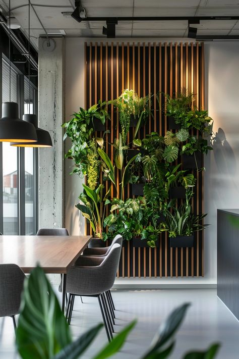 Office Wall Plants, Living Room Green Walls Interior Design, Communal Office Space Ideas, Vestaboard Ideas, Slat Wall With Plants, Wall Design With Plants, Green Wall In Office, Office Wooden Wall Design, Red Office Design