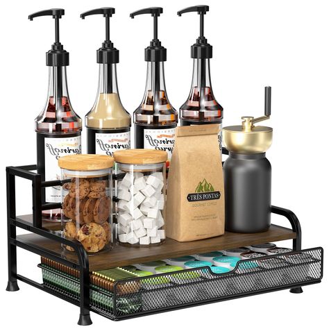 PRICES MAY VARY. [ All-in-One ] Our 3-tier coffee syrup organizer can stand 8 syrup bottles (25.4 oz/750ml) and has a pull-out basket that can store 35 coffee capsules. Stepped design allows for neat placement and easy access to your favorite syrup. Measuring 16" X 9" X 11" with shelves 3.3" and 6" deep. [ Sturdy and Stable ] Our coffee syrup rack is crafted with a sturdy metal frame and solid wood base to ensure stability and load-bearing. Top floor has anti-fall railings to protect bottles. Co Cocktail Coffee Bar, Small Coffee Bar Decor, Small Coffee Bar On Countertop, Small Office Coffee Station Mini Fridge, Coffee Condiment Station, Coffee Drawer Organizer, Conference Room Coffee Station, Coffee Station At Work, Glassware Storage Ideas