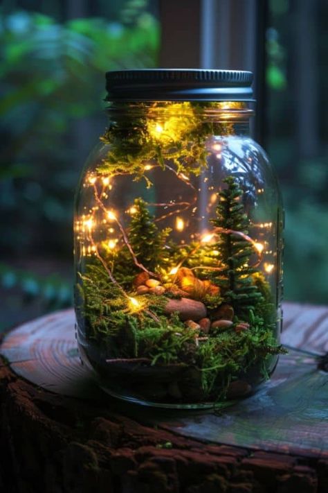 Capture the fairy light in a mason jar. Place a strand of tiny LED lights inside, interwoven with moss and miniatures. #DIY #FairyGarden #Garden #Decor Fairy Lights Crafts Diy Projects, Fairy Mason Jars Diy, Fairy Diy Decor, Tiny Mason Jar Ideas, Fairy Lights In Jar, Fairy Garden Jar, Glowing Mushrooms Diy, Moss Diy Projects, Fantasy Room Decor Diy