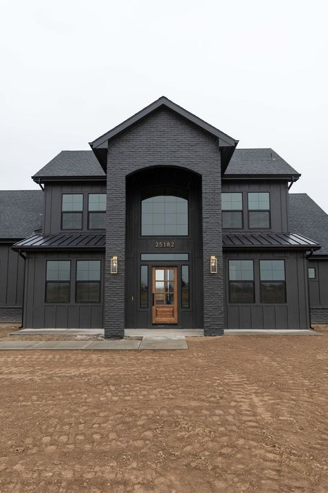 Black Siding And Brick, Blacked Out House, Black Out House, Charcoal Brick House Exterior, Dark Brick Homes Exterior, Black Country House Exterior, Mat Black House, Modern Indoor Paint Colors, Modern Black Home Exterior