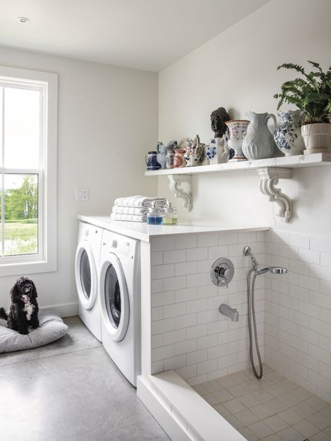 Editor Sara Martin's house on the mountain in Ravenna, Ontario is a true countryside escape! With concrete, tons of light and antiques, and tons of bright white details. Check out the laundry room with white subway tile, vintage pottery and dog bath shower area. Small Utility Room With Dog Wash, Dog Bath Area In Laundry Room, Dog Wash Area In Laundry Room, Laundry With Dog Space, Laundry Shower Room, Laundry Room Design With Dog Wash, Doggie Bath In Laundry Room, Dog Bath Tub In Laundry Room, Small Laundry Room Ideas With Dog Wash