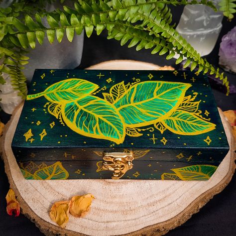 "These fully hand-painted wooden boxes feature my original design of golden leaves on an emerald green base. The boxes are covered with clear high-gloss lacquer to prevent the paint from scratching and for easy cleaning. They are ideal as a jewellery box, pencil case box, DnD dice storage, keepsake, as well as tarot storage, altar decor, ritual and offering box, crystal storage, incense and herbs storage, etc. These boxes can be an excellent custom gift with the personalisation of the inner side of the lid. ► Felt Dividers ADD-ON https://www.etsy.com/uk/listing/1371752802/felt-dividers-add-on-jewellery-crystals ► As the boxes are made to order and completely hand-painted, minor changes to the design will occur. If you have any preferences (i.e. different green colour, change leaf shapes, f Offering Box, Box Pencil Case, Crystal Storage, Travel Altar, Dice Storage, Hand Painted Wooden Box, Painted Wooden Boxes, Painted Jewelry Boxes, Witchy Crafts