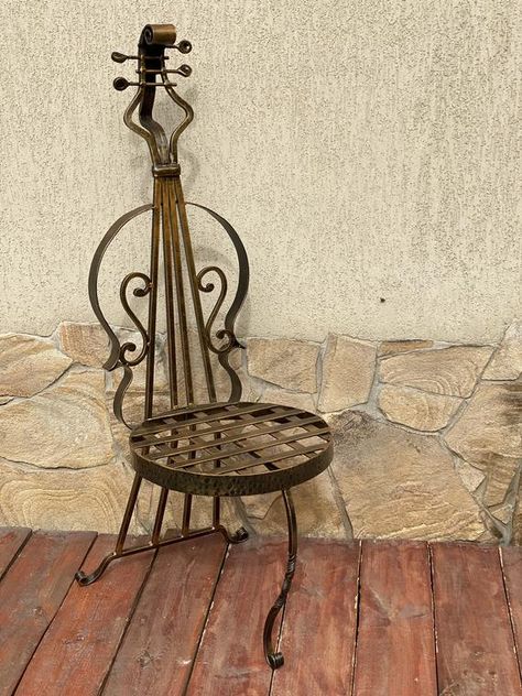 Music chair, chair, piano stool, music gifts, musical gifts, cello, music instruments, musician, music, music band, music decor,guitar stoolHere is a hand forged chair in a view of a music instrument. You will not find anything similar to it. It is very decorative! It is done in the technique of the artistic forging.Sizes: full height - 108 cm (42.53"), depth - 40 cm (15.75"),width - 40 cm (15.75"), Colour: black covered with bronze patina.No cushions go with a chair.I can send it to any country Guitar As Decor, Guitar Stool, Music Home Decor, Musical Gifts, Bronze Anniversary Gifts, Bronze Gifts, Cello Music, Piano Stool, Cute Furniture