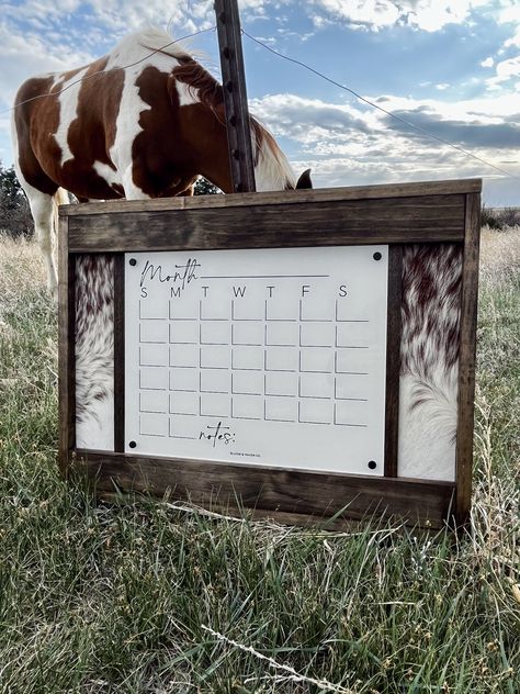 The perfect western calendar that everyone needs!  Handcrafted with premium lumber our signs make the perfect gift, or addition to your own home. We use REAL cowhide. No two signs will be exactly alike. Please note that being a natural cowhide there could be slight yellowing, or marks. Hides can vary! Pictures shown are just an example of the hide color. If you are looking for a specific pattern please message us.  Calendar is 16.75x13.25" and the overall piece is 26x20" Being genuine cowhide no Western Decor Office, Rustic Classy Home Decor, Cowhide Living Room Decor, Western Glam Home Decor, Rustic House Decor Ideas Living Room, Western Wall Decor Diy, Western Entryway Ideas, Western Spare Bedroom, Rustic Southwestern Home Decor