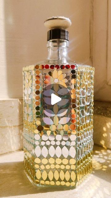 The Art Box by Swati Jain on Instagram: "Mirror Mosaic Art on Bottle - DIY #Commissionedwork #wallmirrors #mosaicartist #mirrormosaic #mosaicart #lippanartwork #instragramart #contentcreators #womanentrepreneur #artvideos #mirrorart #artreelsofinstagram #viralvideos #bottleart #mirrormosaic #mosaicartist #viralart #videoreels" Mirror Mosaic Art, Mosiac Mirror, Bottle Work, Bottles Decoration Diy, Art Facts, Bottle Art Projects, Bottle Paint, Wonder Wheel, Shankar Mahadevan