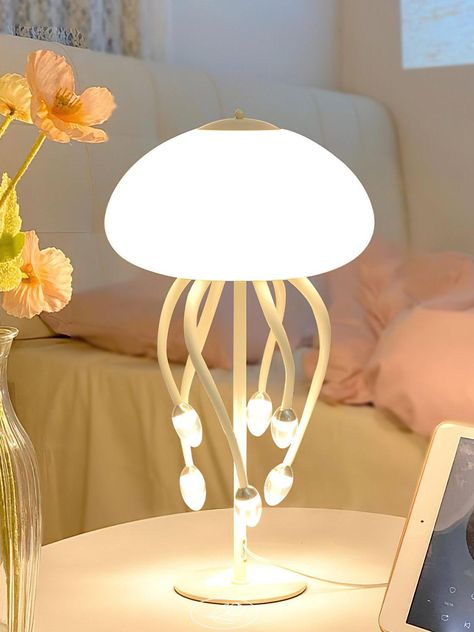 The Jellyfish Table Lamp perfects the elegance in chaos design, featuring a delicate and transparent body that replicates jellyfish texture. This unique and whimsical lamp fills your home with art and life, creating an atmosphere of wonder and joy. Experience the beauty of free space with this one-of-a-kind lamp. 
 If you have any questions about our products, please contact us and we will get back to you within 24 hours. 
 >>> 
   
 Product Size 
 6+1 Heads Size: Dia 40cm x H 70cm /  15.7 x H 27.6 
 
 9+1 Heads Size: Dia 40cm x H 70cm /  15.7 x H 27.6 
 
 Details 
 Material: Metal, Acrylic . 
 Light source: Integrated LED (LED lights are fully built into the fixture and cannot be replaced). 
 Kelvin range: Warm Light (3000K), Neutral Light (4000K), Cool Light (6000K). 
 Voltage: Jellyfish Texture, Whimsical Lamp, Animal Lamp, Lighting Uk, Smart Home Appliances, Art Appliqué, Unique Lamps, Free Space, Unique Lighting