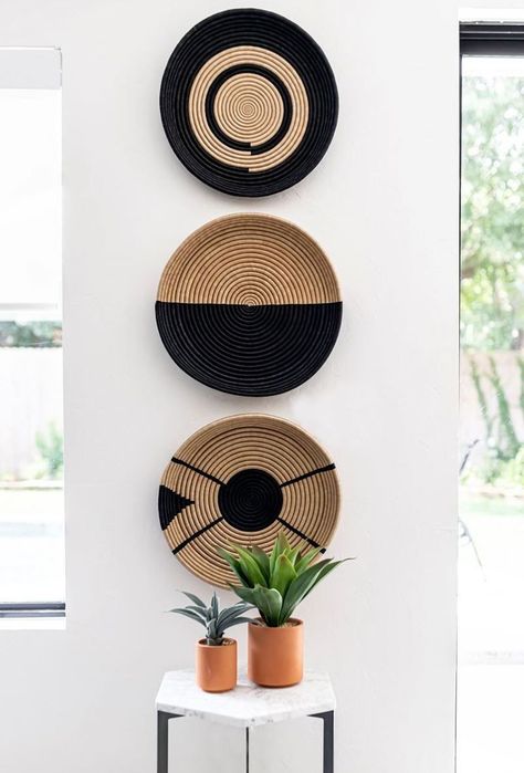 Add three plates of the same size vertically to spruce up your narrow wall space. Creating moments of intention— even in the smallest places— will make your space feel more unique and lived-in. Woven Wall Hanging Baskets, Modern Basket Wall, Woven Plates On Wall, Narrow Wall Decor Ideas, Narrow Wall Decor, Vertical Wall Decor, Woven Wall Baskets, Vertical Art, African Wall Baskets