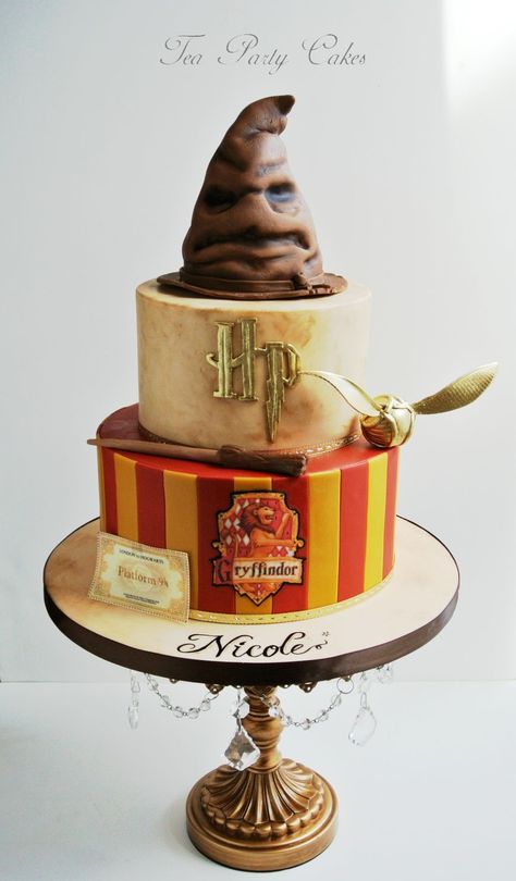 This Harry Potter Cake is kind of amazing! - "I made this Harry Potter cake for a friend's daughter who was turning 18.  I tried to make it a little more sophisticated and grown up to reflect this significant milestone.  6 and 8 inch cakes covered in fondant.  The sorting hat is made from RKT and is covered in fondant and accented with petal dusts.  The snitch, wand and HP are fondant and the train ticket and Gryffindor crest are edible images.  TFL!" Tort Harry Potter, Gateau Harry Potter, Kid Cakes, Harry Potter Birthday Cake, Glume Harry Potter, Harry Potter Bday, Festa Harry Potter, Anniversaire Harry Potter, Harry Potter Birthday Party