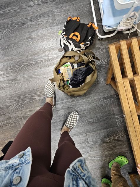 Feet wearing neutral checkered vans and brown yoga pants. The feet stand next to an open army green tote overflowing with snacks, a wallet and essentials. Brown Checkered Vans Outfit, Checkered Vans Outfit, Brown Checkered, Mom Wardrobe, Vans Outfit, Checkered Vans, Fall Style, Your Mom, A Class