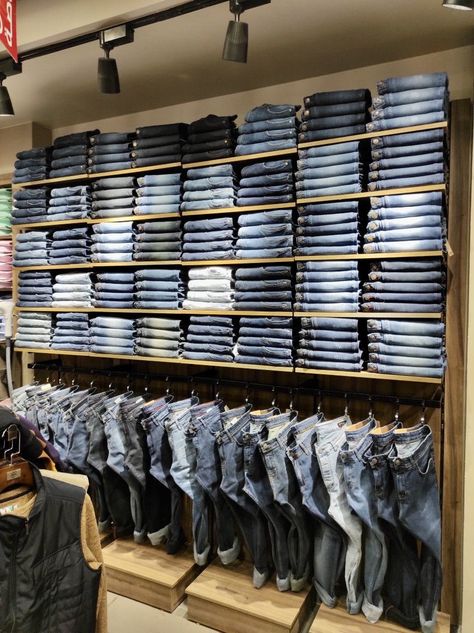 Boutique Storage Room, Retail Interior Design Boutique Clothing Stores, Jeans Display Ideas Retail Stores, Cloth Shop Interior Design Retail, Clothing Store Displays Men's, Clothes Showroom Interior Design, Boutique Shelves, Men's Clothing Store Design, Small Clothing Store Interior