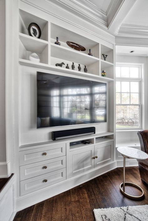 We adjusted the corner cabinetry for the TV to fit perfectly into the space, in addition to giving these homeowners some open shelves to display some treasured family items. #familyroom #livingroom #livingroomdecor #homedecor #interior Built In With Tv, Corner Built In Shelves, Tv In Corner Of Living Room, Corner Tv Ideas, Corner Cabinet Living Room, Tv Family Room, Corner Entertainment Center, Corner Built In, Tv Corner