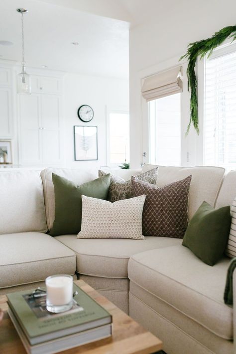 Green Living Room Christmas Decor, Spring Cushions Living Rooms, Living Room Green Pillows, Cream Sofa Green Cushions, White Living Room With Green Accents, Cream And Sage Green Living Room, Sage Green Pillows Living Room, Nuetral Pallete Living Room With Green, Green And Tan Living Room