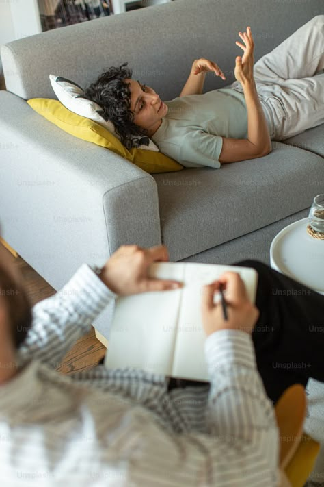 A man laying on top of a couch next to a woman photo – Therapist Image on Unsplash Therapist Couch, 1111 Portal, Therapist Photoshoot, Headshots Poses, Therapy Couch, Career Manifestation, Craniosacral Therapy, Therapist Office, Happy Images