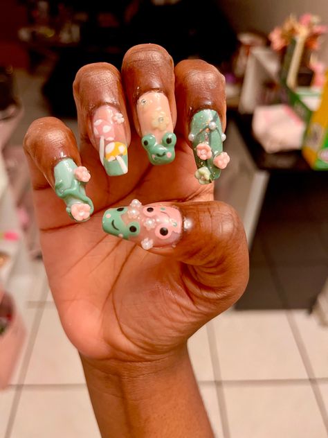 Pink and green themed cottagecore frog nails Frog And Mushroom Acrylic Nails, Froggy Nails, Frog Nail Art, St Patricks Nail Designs, Frog Nails, My Froggy Stuff, Saint Patrick Nail, Froggy Stuff, Cottagecore Frog