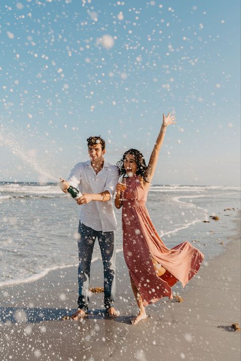 Engagement session at Jacksonville Beach Florida | sweetest champagne spray by Madison Shea Photography based in North Florida Engagement Photos Inspo Beach, Classy Beach Engagement Photos, Engagement Pictures Poses Beach, Props For Engagement Photos, Engagement Photo Shoot Ideas Beach, Beach Engagement Photography, Engagement Shoot At The Beach, Beach Engagement Shoot Ideas, Summer Engagement Photos Beach