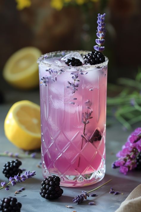 Refreshing lavender lemonade garnished with blackberries and lavender sprigs in a decorative glass, surrounded by fresh lemons and lavender. Blackberry Drink, Lavender Lemonade Recipe, Lavender Scones, Blackberry Lavender, Blackberry Drinks, Blackberry Lemonade, Lemon Juice Water, Lavender Recipes, Culinary Lavender