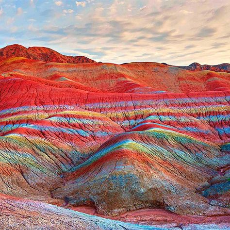 The Zhangye National Geopark is located in Sunan and Linze counties within the prefecture-level city of Zhangye, in Gansu, China. Zhangye Danxia is known for the unusual colours of the rocks, which are smooth, sharp and several hundred meters tall. They are the result of deposits of sandstone and other minerals that occurred over 24 million years. Wind, rain, and time then sculpted extraordinary shapes, including towers, pillars, and ravines, with varying colours, patterns, and sizes.
#China Rainbow Mountains China, Zhangye Danxia Landform, Zhangye Danxia, Danxia Landform, Rainbow Island, Rainbow Mountains, Landform, Iran Travel, Colorful Mountains