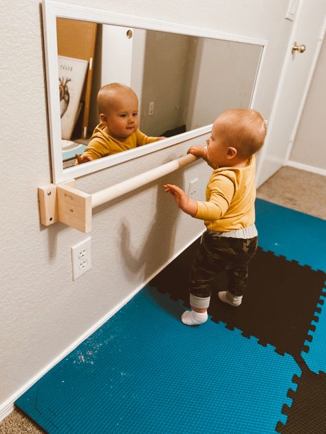 DIY baby pull up bar for Montessori based play room Baby Playroom Mirror, Montesorri Room Ideas, Monestorri Nursery, Montessori Infant Playroom, Diy Montessori Playroom, Montessori Bedroom Diy, Infant Pull Up Bar Diy, Playroom For Infants, Diy Montessori Pull Up Bar