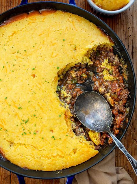 Cornbread Cowboy Casserole is made with a cowboy baked bean and ground beef base, and a delicious cheesy cornbread topping. Cowboy Casserole, Casserole Recipes, Cornbread Casserole, Cornbread Meat Casserole, Dinner, Supper, Campfire Recipes, Camping Recipes, Dinner Recipes, Hearty Dinner Recipe, i am homesteader, iamhomesteader Cast Iron Cowboy Casserole, Recipes To Go With Cornbread, Cornbread Skillet Casserole, Homemade Cornbread Casserole, Cowboy Skillet Casserole, What To Eat Cornbread With, Cowboy Dinner Ideas, Main Dishes For Dinner Beef, Southern Cornbread Casserole