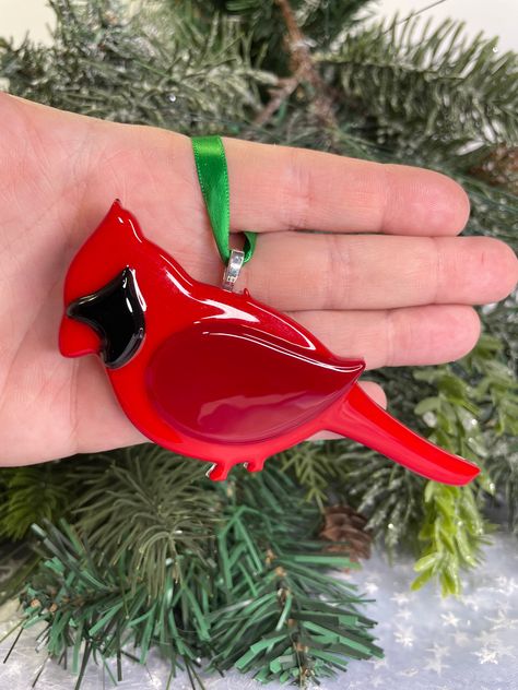 This is a Fused Glass Cardinal Ornament. He is the perfect gift for that Bird Watcher or Ornament Collector. He can hang in your kitchen, at the office, in your car or on your Christmas Tree. He started his life as sheet glass, which I cut, stacked and "cooked" in my home studio kiln. Once annealed for strength and cooled, I gave him a silver bail and a colorful ribbon to complete him. Now he can sing his way into your heart. ❄️ SIZE4" tall and 4 1/4" wide Fuse Glass Christmas Ornaments, Glass Fusion Birds, Fused Glass Cardinal Pattern, Fused Glass Cardinals, Fused Glass Dog Ornament, Fused Glass Christmas Tree Ornaments, Fused Glass Cardinal, Fused Glass Ornaments Ideas, Christmas Fused Glass Ornaments