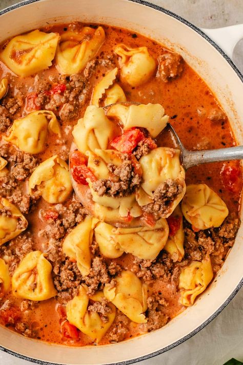 A tasty, creamy Beef Tortellini Soup recipe that the whole family will love. Made with ground beef, diced tomatoes, onions, beef broth, cream, and tortellini. This flavorful soup is the perfect for chilly days or when you're craving something comforting and hearty. Slow cooker option included. Creamy Beef Tortellini, Beef Tortellini Soup, Beef Broth Soup Recipes, Ground Beef Diced Tomatoes, Tortellini Soup Crockpot, Beef Tortellini, Slow Cooker Ground Beef, Creamy Tortellini Soup, Recipes Using Ground Beef