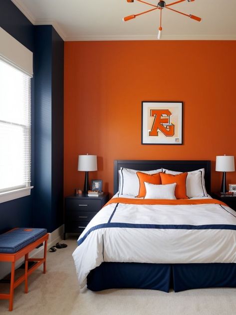 Create a vibrant and energetic boys bedroom by adding an orange accent wall, complemented with a cool sports-themed wallpaper. Complete the look with sleek black furniture and pops of blue for a modern and stylish space. Orange Accent Wall, Orange Bedroom Ideas, Orange Accent Walls, Sports Themed Bedroom, Blue Boys Bedroom, Orange Bedroom, Bedroom Orange, Black Furniture, Orange Accents