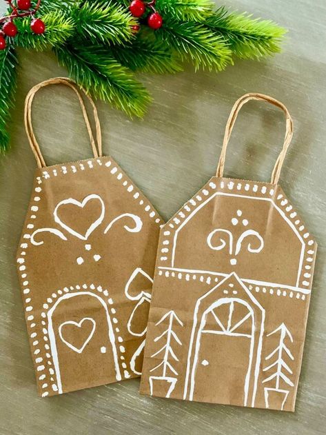 Looking for a fun and creative way to personalize your gifts this holiday season? Why not try making these adorable Holiday Gingerbread House gift bags. Not only are they a great way to repurpose a boring brown paper bag, they also look so festive when placed in a grouping under the Christmas tree.This DIY is extremely simple to make, and a perfect activity for even children to create... In fact, I think these personalized Gingerbread house bags would be perfect to wrap up teachers gif… Diy Gingerbread House Gift Bag, Decorating Paper Bags For Christmas, Gingerbread House Bag Craft, Brown Paper Bag Gingerbread House, Gingerbread House Brown Paper Bag, Brown Paper Gingerbread House, Brown Bag Gift Bags, Gingerbread Gift Bags, Gingerbread House Gift Bag