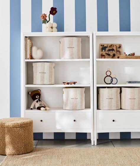 Our soft pink and white striped Cove shelf storage bin offers a stylish way to keep kids' rooms tidy and organized. The organic brushed cotton container adds a fresh, playful touch to a kid's bedroom or playroom with its wide textured stripes and neat cutout handles that make it easy to tote around.   • 100% organic cotton shell and lining, grown without chemicals or pesticides  • This item can be personalized with a name or monogram, available in multiple fonts and colors  • Personalization not Tall White Bookcase, Kids Storage Solutions, Kids Storage Bins, Kids Play Table, Bookcase With Drawers, Cube Storage Bins, White Bookcase, Kid Toy Storage, Kids Bookcase