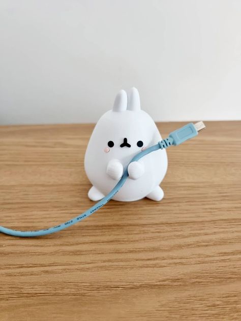 This adorable Bunny will hold your favourite cable with commitment. Can't be cuter than that! Perfect for your smartphone, iPad, iPhone cables. Use it wherever you need a little friend to hold your cable: Desk, Table, Kitchen counter, Nightstand or Car Dashboard. At home or the office! Guaranteed 100% Kawaii!  Our bunny is heavy enough to hold your USB cable. If you select the RAINBOW colour; I cannot guarantee it will be the same colours as shown in the images. Your item will be whatever colour Clay Cable Holder, Cable Holder Diy, Kawaii Miniatures, Clay Desk Accessories, Bunny Items, Desk Friend Clay, Desk Friend, Clay Phone Holder, Clay Classes