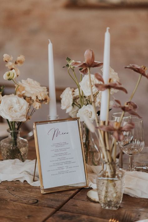 White taper candles in gold candleholders with pale pink and white wedding flowers with a menu stationery in a gold photo frame Cozy Romantic Wedding Theme, Wedding Dress With Split, Wedding Stationery Ideas, Neutral Wedding Decor, Menu Table, Place Cards Wedding, Pink And White Weddings, Stationery Ideas, Vow Books