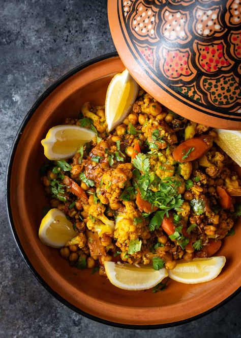 This recipe for vegetable tagine makes a hearty Moroccan dish with carrots, cauliflower, and chickpeas in a flavorful, aromatic stew. Moroccan Tagine Recipes Vegetarian, Vegan Tagine Recipes, Vegetarian Tagine Recipes, Moroccan Vegetarian Recipes, Tagine Recipes Vegetarian, Moroccan Vegan, Bohemian Recipes, Cauliflower Stew, Vegetarian Tagine