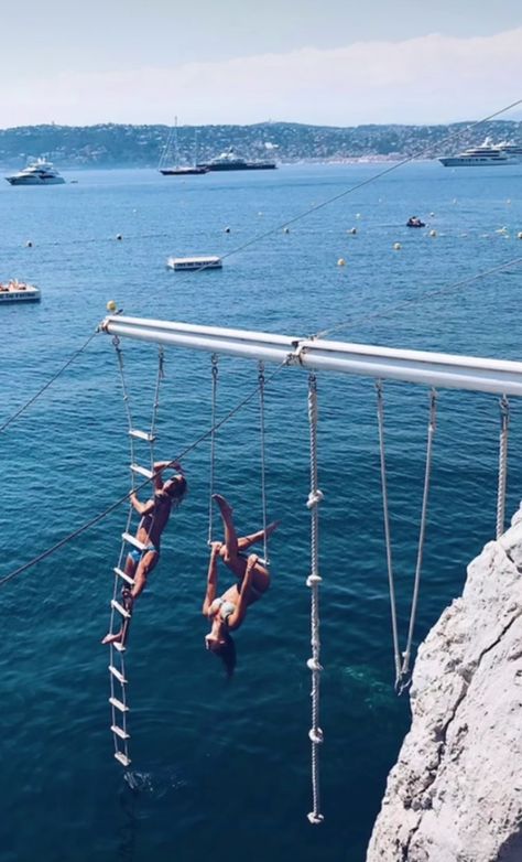 Two women in swimsuits hanging from rope swings suspended from a cliff over the Mediterranean sea Hotel Du Cap Eden Roc, Hotel Du Cap, Eden Roc, Juan Les Pins, The French Riviera, Wildest Dreams, Bucket List Destinations, The South Of France, Ancient Ruins