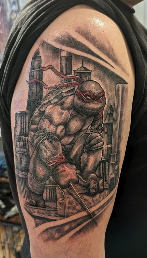 Black and white tattoo of a ninja turtle with red bandana at the top of a building on the arm of a man Ninja Turtle Sleeve Tattoo, Raphael Tmnt Tattoo, Ninja Turtles Tattoo Ideas, Tmnt Tattoo Ideas, Teenage Mutant Ninja Turtles Tattoo, Wales Tattoo, Raphael Tattoo, Ninja Turtles Tattoo, Tmnt Tattoo