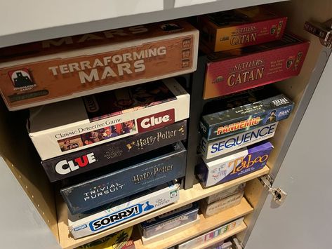 Boardgames organized in cabinets. Game Cabinet Organization, Organize Deep Cabinets, Game Cabinet Storage, Game Storage Cabinet, Board Game Storage Cabinet, Kitchen Pans Organization, Organize Board Games, Dvd Storage Ideas, Board Game Shelf