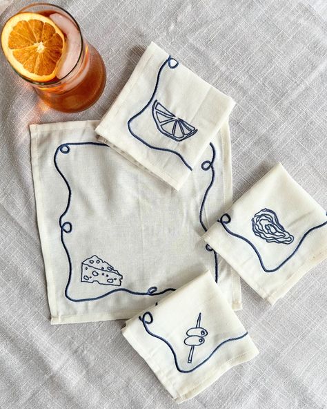 Happy long weekend!🧡 We hope you are celebrating with an Aperol Spritz (or a glass of wine from @chinchincreemore !) and some appetizers paired with our embroidered napkin sets✨ The perfect gift for nights at a friend’s house. Did you know Laurie drew the illustrations, Tessa digitalized them and we had them embroidered? Each set (Apero, Veggies, Hi!, and Bathers) come with 4 unique illustrations #tablescape #hostessgift #summerdinner #summerevenings #summerparty #cockatil #cocktailparty #ap... Handmade Craft Gift Ideas, Cloth Napkins Embroidery, Embroidery Designs For Napkins, Table Napkin Embroidery Ideas, Hand Embroidery Cocktail Napkins, Diy Embroidered Napkins, Cocktail Napkin Embroidery, Embroidered Napkins Ideas, Embroidered Dinner Napkins