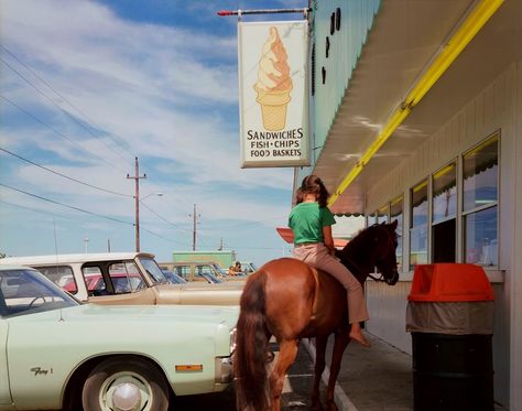 “This photograph could be the opening line of a joke: ‘So, a girl rides up to a bar on a horse...’” says Joel Meyerowitz. “But really what happened was that I was there getting some ice cream for my kids when this girl rode up to the window on her horse and ordered two lobster rolls and some fries; as soon as I saw the girl, the horse, and the ice cream sign, I saw the photograph.” Joel Meyerowitz, Mary Ellen Mark, Nan Goldin, Night Walkers, Edward Weston, Steve Mccurry, Martin Parr, Robert Doisneau, Freddy Mercury