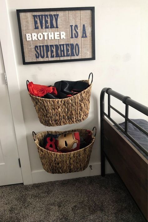 Needing simple storage ideas and solutions for your boys bedroom? I needed a simple but cute way to store my boy’s superhero capes and masks, but easy enough for them to put away when it was time to clean up. So I went to the craft store and got a pre-made sign (similar one linked here) and some wooden letters to make a sign that said “Every Brother is a Superhero." I then added baskets underneath for toy storage. Find more DIY Storage Ideas at https://spetrichhome.com/! Boys Room Storage, Star Wars Boys Bedroom, Fun Boys Bedroom Ideas, Marvel Boys Room, Boys Bedroom Storage, Diy Storage Ideas, Marvel Bedroom, Easy Diy Home Projects, Boy Toddler Bedroom