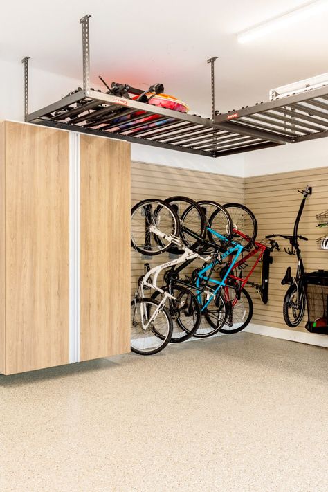 Lighter wood, brighter space! Our light wood cabinets and overhead storage turned this cluttered mess into an organized area! Garage Flooring Options, Garage Inspiration, Epoxy Garage Floor Coating, Garage Transformation, Garage Storage Inspiration, Iron Furniture Design, Wall Storage Systems, Overhead Garage Storage, Garage Floor Coatings