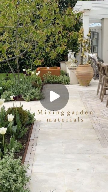 Debbie Harris on Instagram: "Morning all - what a challenging week I’ve had so I’m so glad it’s the weekend. Sharing how I’ve mixed materials in the garden to create interest. So here you see the warm contrast of the Corten steel edging and also for the water feature against the limestone slabs and the limestone pavers. Lots of people think these are tiles but they are block pavers, cleverly laid to exactly the same level as the slabs around them, shown here to create this rug effect that I wanted under my table. The materials work well together and are far more interesting like this.
Worth also pointing out I asked for the pavers to be laid with a mix of smooth and rough side facing up to get different textures and colour tones in the herringbone pattern.

Hair appointment this morning th Mixed Patio Materials, Patio To Garden Transition, Limestone Tiles Outdoor, Front Stone Patio, Patio Extension With Pavers, Garden Tiles Outdoor Ideas, Garden Pavers Ideas, Outside Tiles Front Porches, Grassless Garden