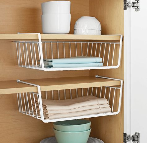 A set of two under-the-cabinet baskets that'll give you extra shelves for hiding stuff that can't fit in your cupboards. When you're living in an overpriced apartment with a tiny kitchen, every 👏 space 👏 counts 👏. Basket Walmart, Under Shelf Storage, Under Shelf Basket, Under Cabinet Storage, Used Cabinets, Cube Storage Bins, Space Saving Kitchen, Basket Storage, Lid Storage