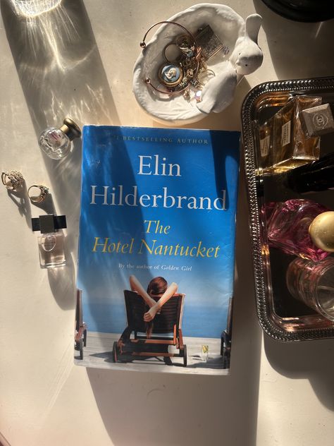 The book Hotel Nantucket next to a bowl of jewelry and perfume The Hotel Nantucket Book, The Hotel Nantucket Book Aesthetic, Hotel Nantucket Book, The Hotel Nantucket, Hotel Nantucket, Christmas Must Haves, Elin Hilderbrand Books, Elin Hilderbrand, Nantucket Hotels