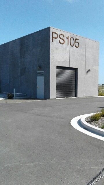 Concrete bunker with black roller door Concrete bunker Concrete Warehouse, Concrete Bunker, Warehouse Project, Roller Door, Roller Doors, Brutalism, Interior Architecture, Garage Doors, Garage