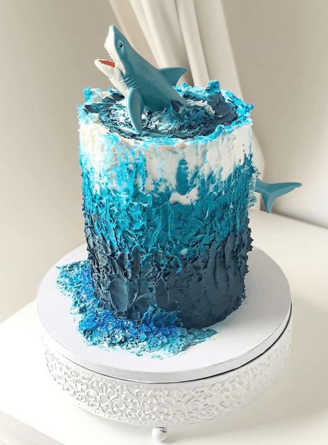 Shark Cake Design Images (Shark Birthday Cake Ideas) Sea Cakes Birthday, Shark Smash Cake, Boys Birthday Cake Ideas, Shark Themed Cakes, Sea Birthday Cake, Shark Birthday Cake, Ocean Birthday Cakes, Shark Cupcakes, Shark Birthday Cakes